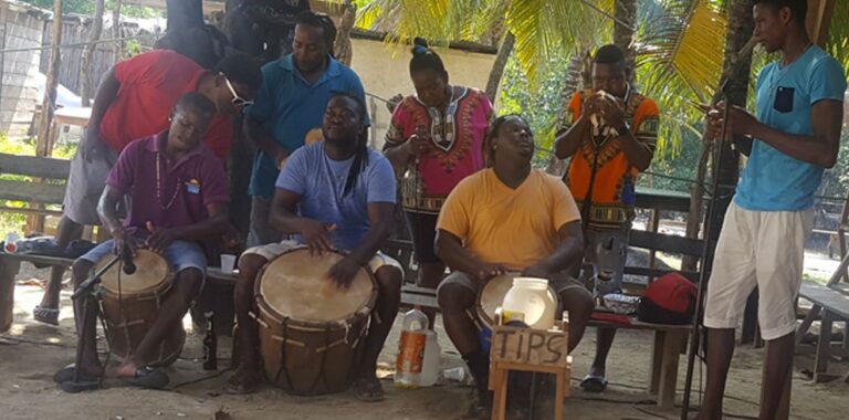 Garifuna musicians playing drums and singing together