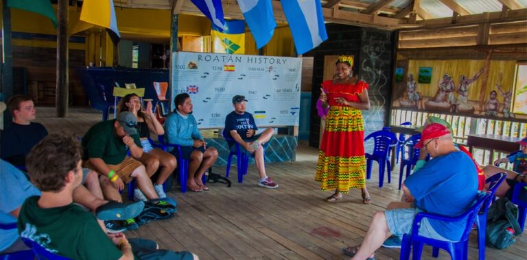 A woman sharing Garifuna history with visitors in Punta Gorda